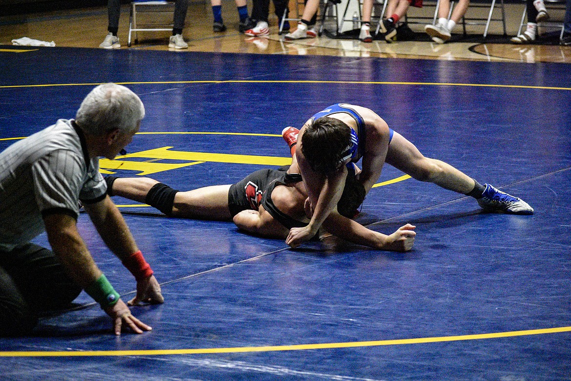 Libby junior Trey Thompson gets a near-fall against Sandpoint&#146;s Brady Nelson, winning by a 10-1 major decision, Jan. 3 in Libby. (Ben Kibbey/The Western News)