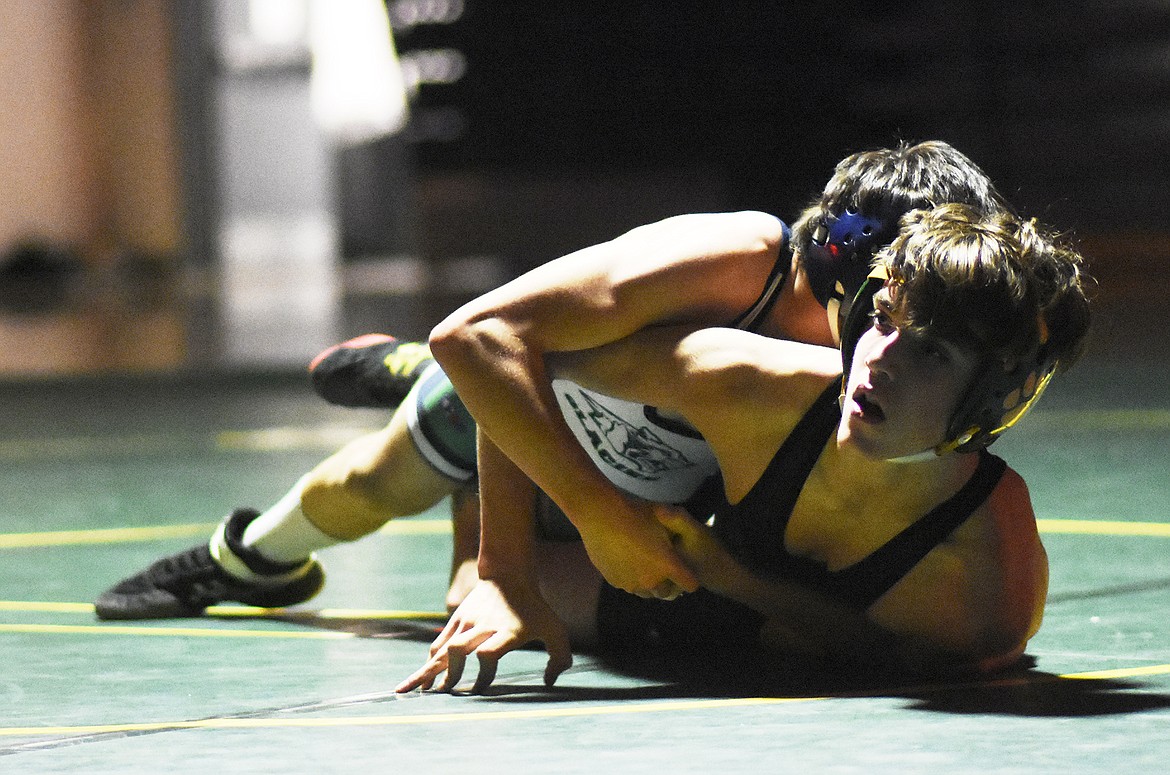 Whitefish&#146;s Casey Conkle grapples Glacier&#146;s Thomas Putnam during a dual last Tuesday. (Daniel McKay/Whitefish Pilot)