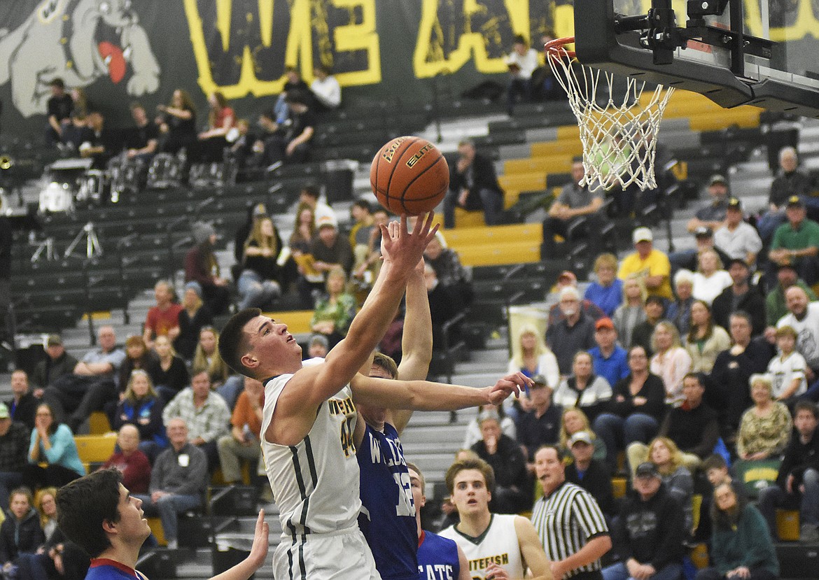 Lee Walburn flies through the lane for the finger roll during the Bulldogs&#146; 60-45 win over Columbia Falls on Thursday. (Daniel McKay/Whitefish Pilot)
