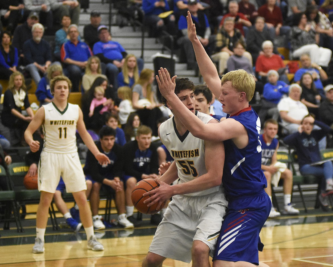 Dillon Botner backs down a Wildcat defender during the Bulldogs&#146; 60-45 win over Columbia Falls on Thursday. (Daniel McKay/Whitefish Pilot)