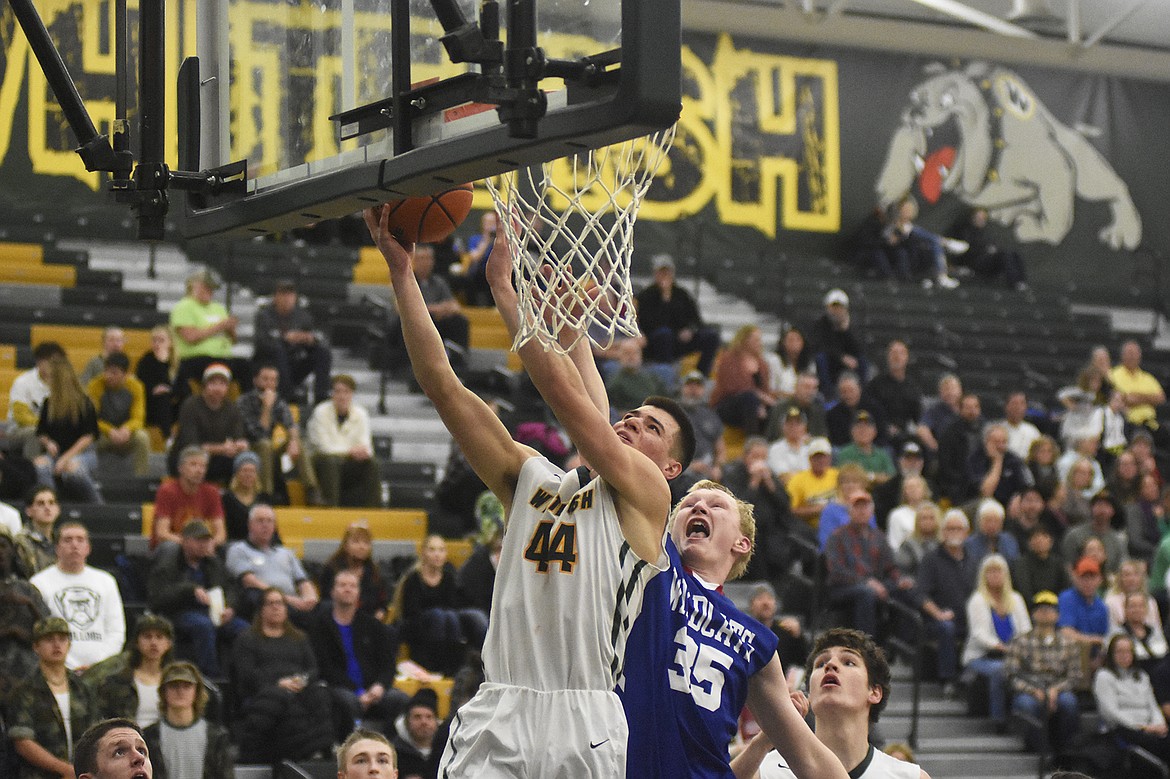 Lee Walburn fights through the contact during the Bulldogs&#146; 60-45 win over Columbia Falls on Thursday. (Daniel McKay/Whitefish Pilot)