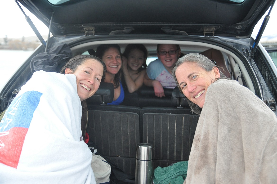 Left to right are Virginia Harris, Amy Pavlock, Thor Pavlock-Moses, Marina Kestner-Pavlock and Lisa Pavlock, drying off and warming up after taking part in their first Polar Plunge in Polson on New Year&#146;s Day. (Ashley Fox/Lake County Leader)