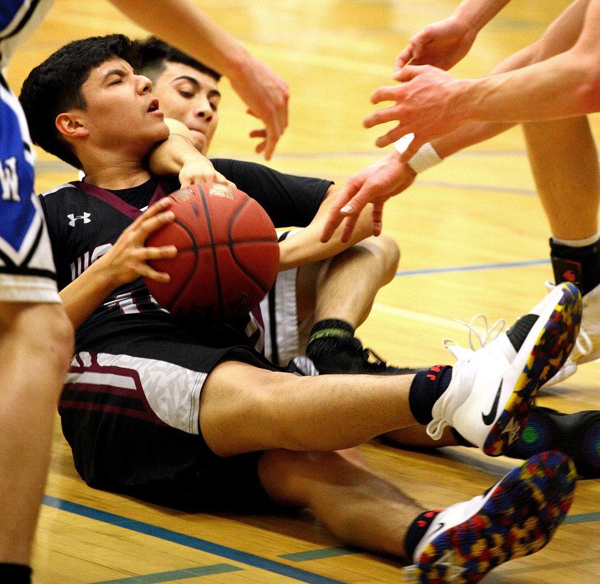 Rodney Harwood/Sun TribuneWahluke sophomore David Ramirez (10) comes up with a loose ball in the midst of all the Warden players during SCAC East action.