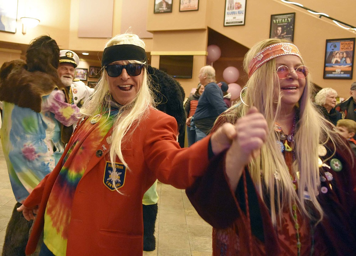 Dressed in hippie attire, past Carnival royalty dance Saturday at the O&#146;Shaughnessy Center following a ceremony announcing the 2019 Winter Carnival King and Queen. The theme for this year&#146;s carnival is Woodstock Whitefish. (Heidi Desch/Whitefish Pilot)