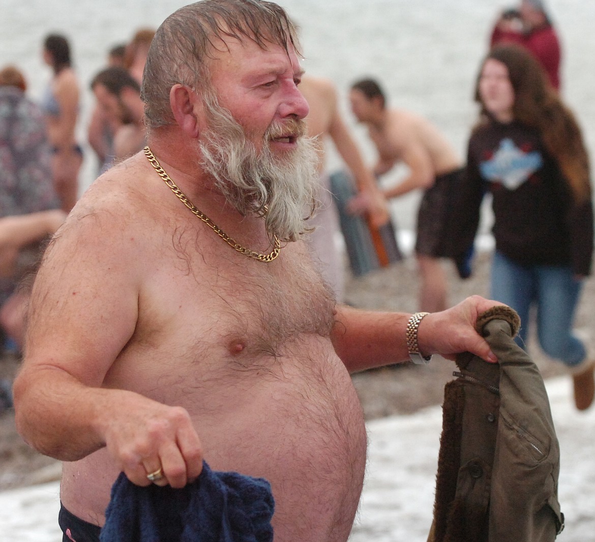 Melvin Quakenbush, 68, grabs his clothes after partaking in the Polson Polar Plunge on New Year&#146;s Day. He has participated for the last five years and said he would &#147;do it again.&#148; (Joe Sova/Lake County Leader)