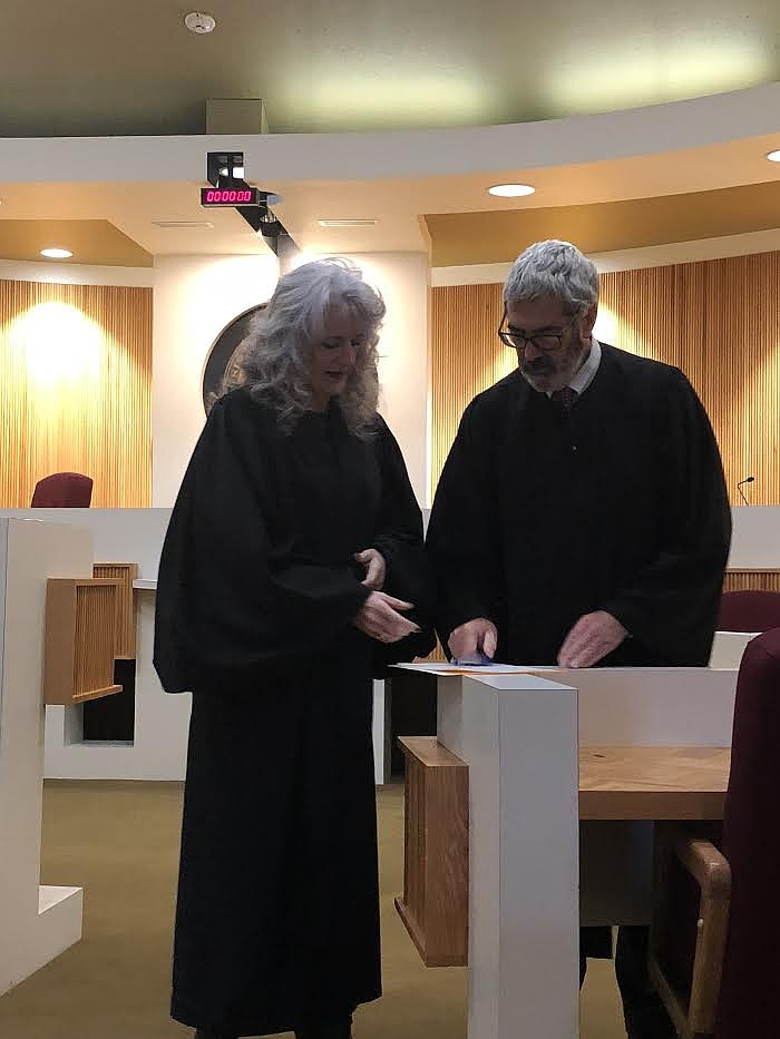 Deborah “Kim” Christoph-er signs an oath as she is sworn in for her fourth term as District 20 Court Judge in Helena on Jan. 2. (Photo provided)