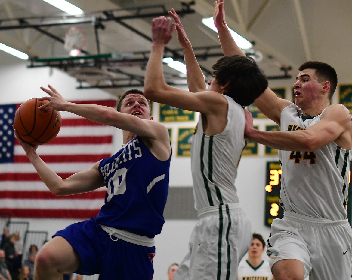 Dillon Wanner takes a tough shot against the Bulldogs in Whitefish Thursday. (Jeremy Weber photo)