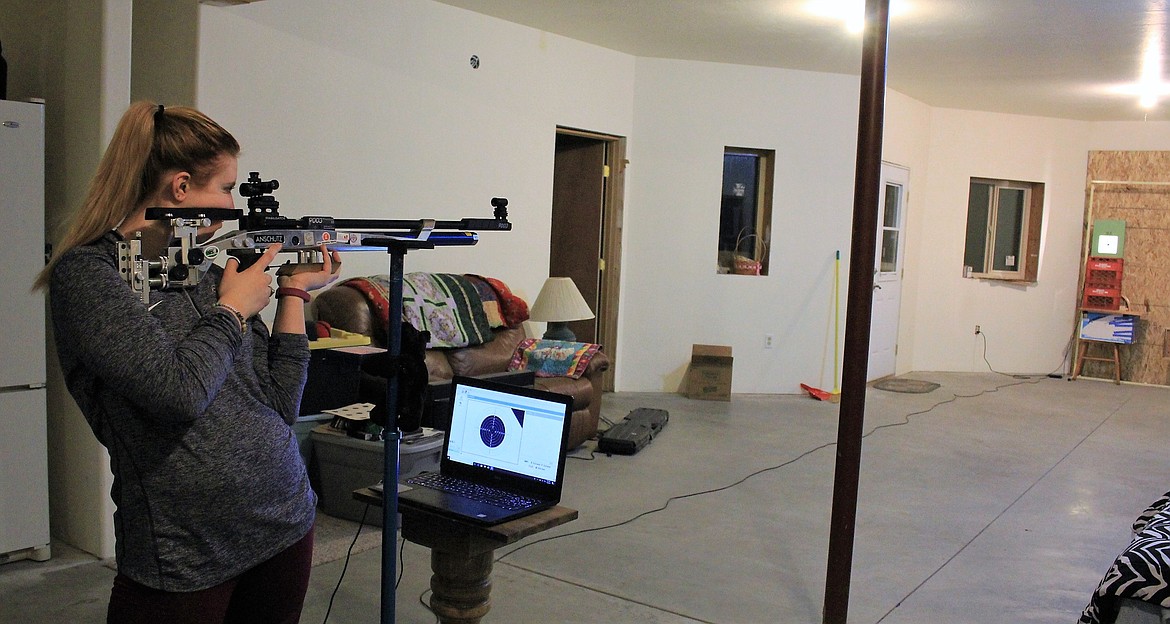 Superior High School student, Jonna Rae Warnken spends most mornings practicing shooting in her basement before classes begin. She was recently awarded a scholarship to the University of Texas at El Paso. (Kathleen Woodford/Mineral Independent)