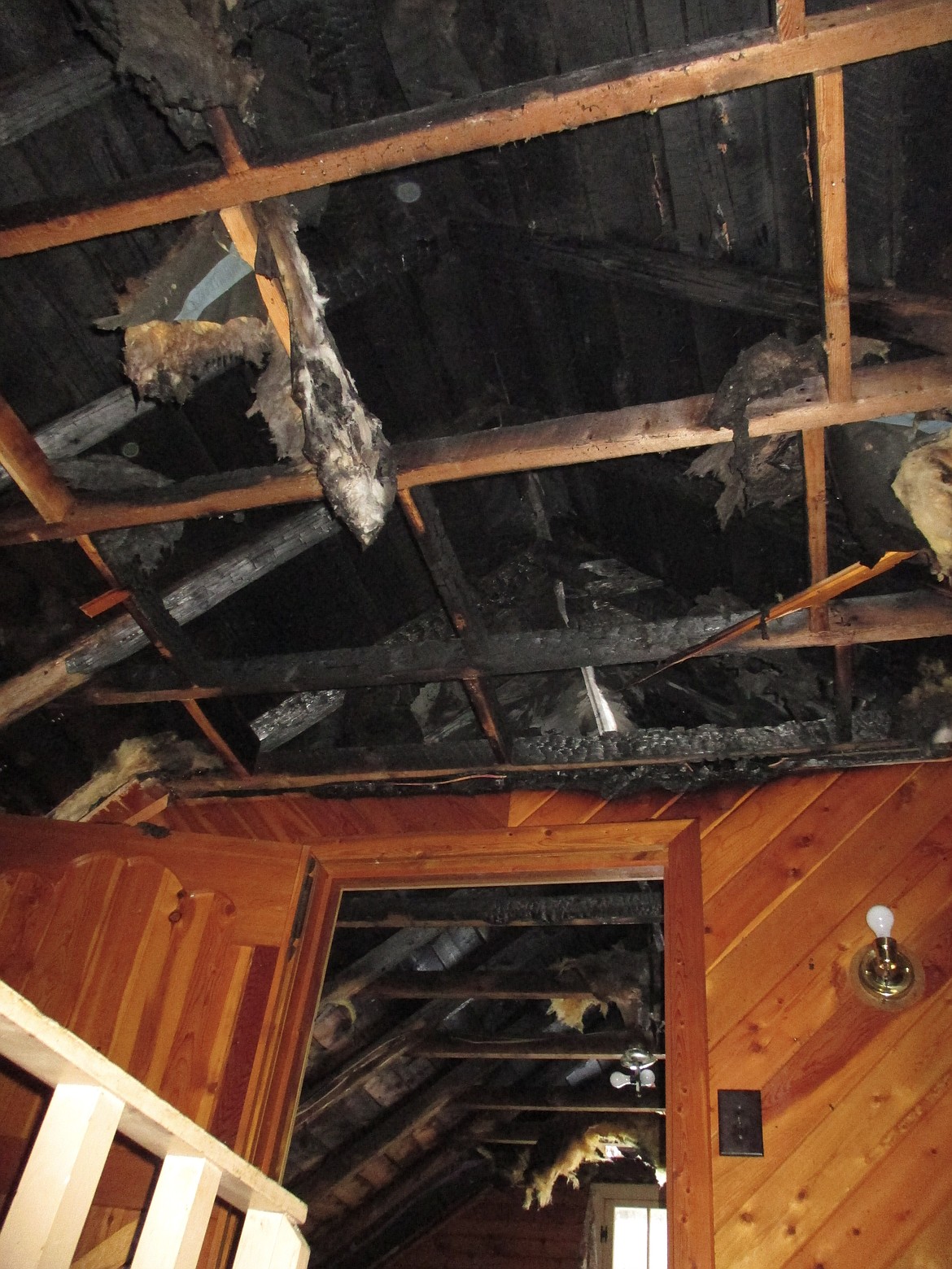 Firefighters from the Upper Yaak VFD removed most of the ceiling in above the second floor as they worked to make sure the fire was completely out. (Photo courtesy Mike Sanders)