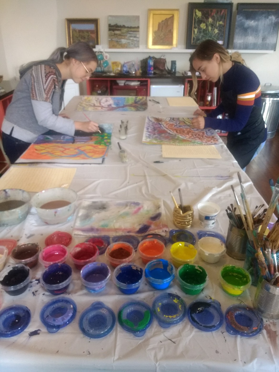 Students Andrea Johnson, left, and Rachel Hughes paint during a mentee workshop in Redbrick Art Studio in November. Rachel is working with Redbrick artist Chelsea Cordova to implement a new arts program at Venture High School. (Courtesy photo)