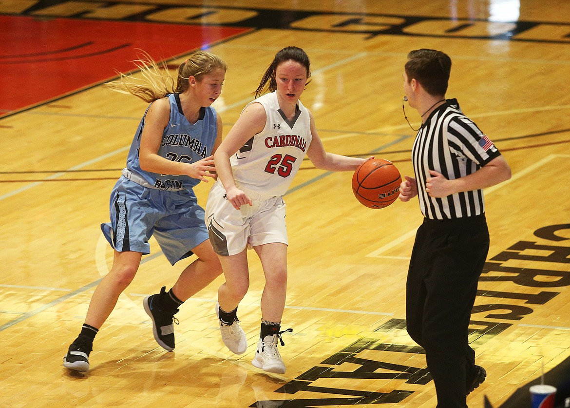 Madison Lommen of North Idaho College dribbles the ball along the edge of the court while defended by Megan Haugen of Columbia Basin.