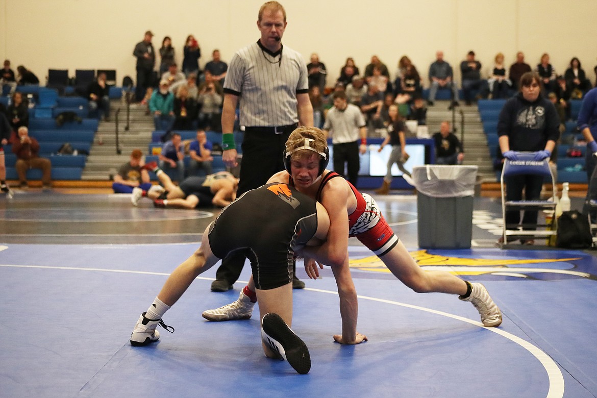 (Photo by KYLE CAJERO)
Sandpoint senior Casey Olesen holds back Post Falls wrestler Lane Reardon during the North Idaho Rumble&#146;s 120-lb. semifinals.