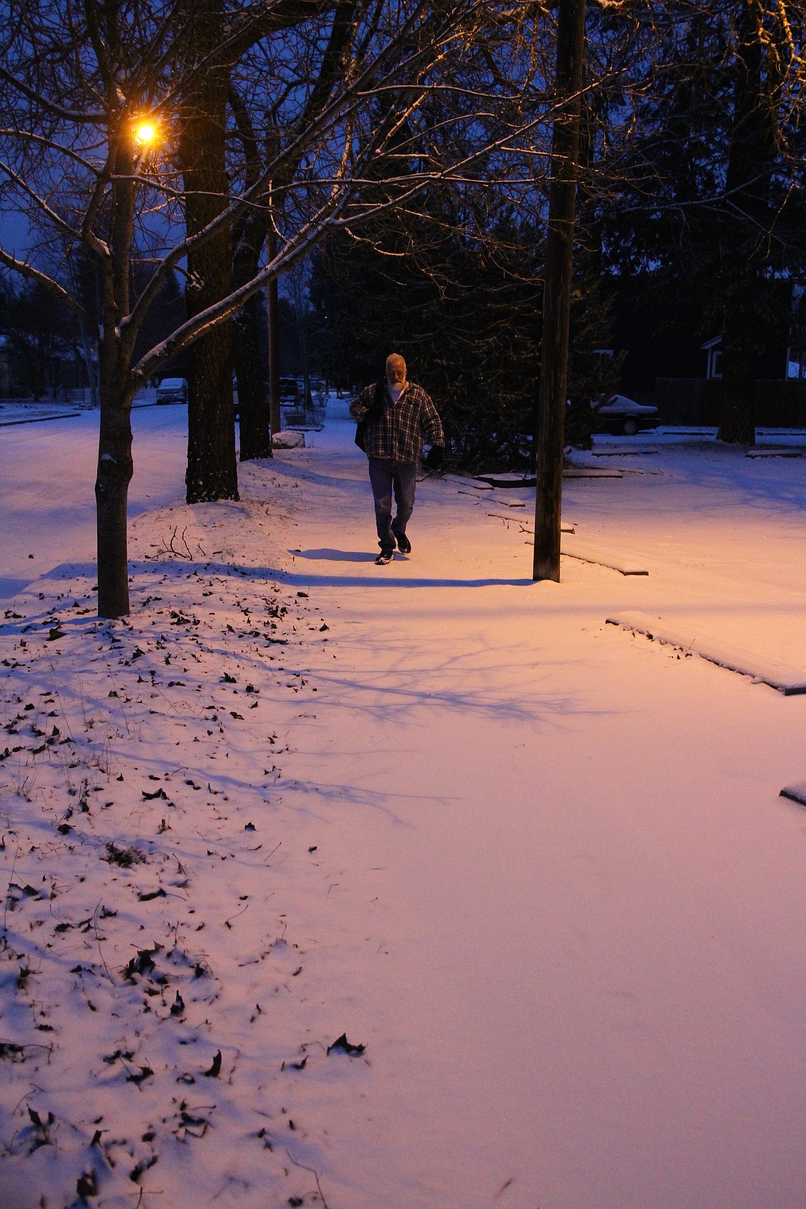 Wiley Hunter walks in early January along his daily route between the Coeur d'Alene Public Library and the halfway house he calls home. (ANDREAS BRAUNLICH/Press)