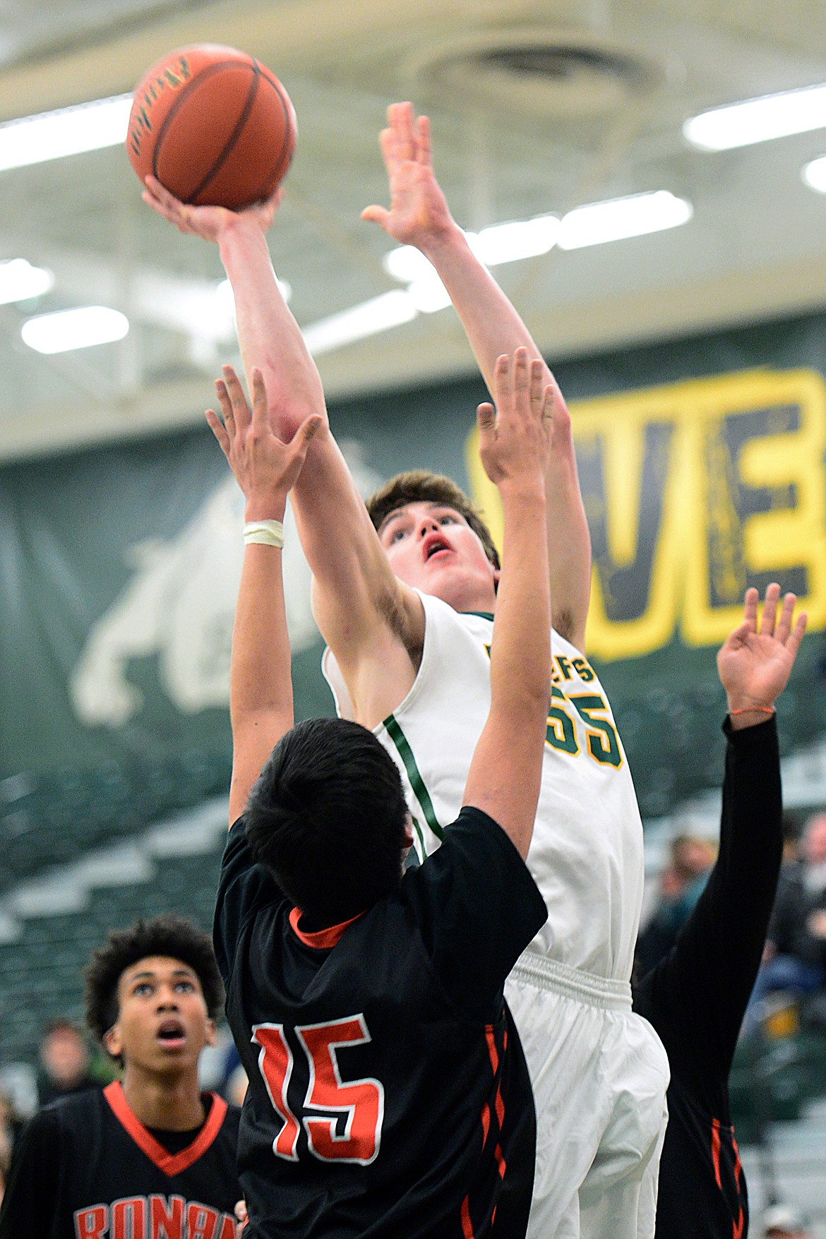 Whitefish's Dillon Botner (55) goes to the hoop over Ronan's Aidan Birdinground (15) at Whitefish High School on Tuesday. (Casey Kreider/Daily Inter Lake)