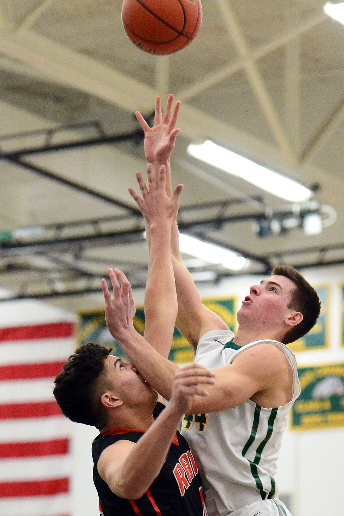 Whitefish's Lee Walburn (44) drives to the basket against Ronan's Ruben Couture (4) at Whitefish High School on Tuesday. (Casey Kreider/Daily Inter Lake)