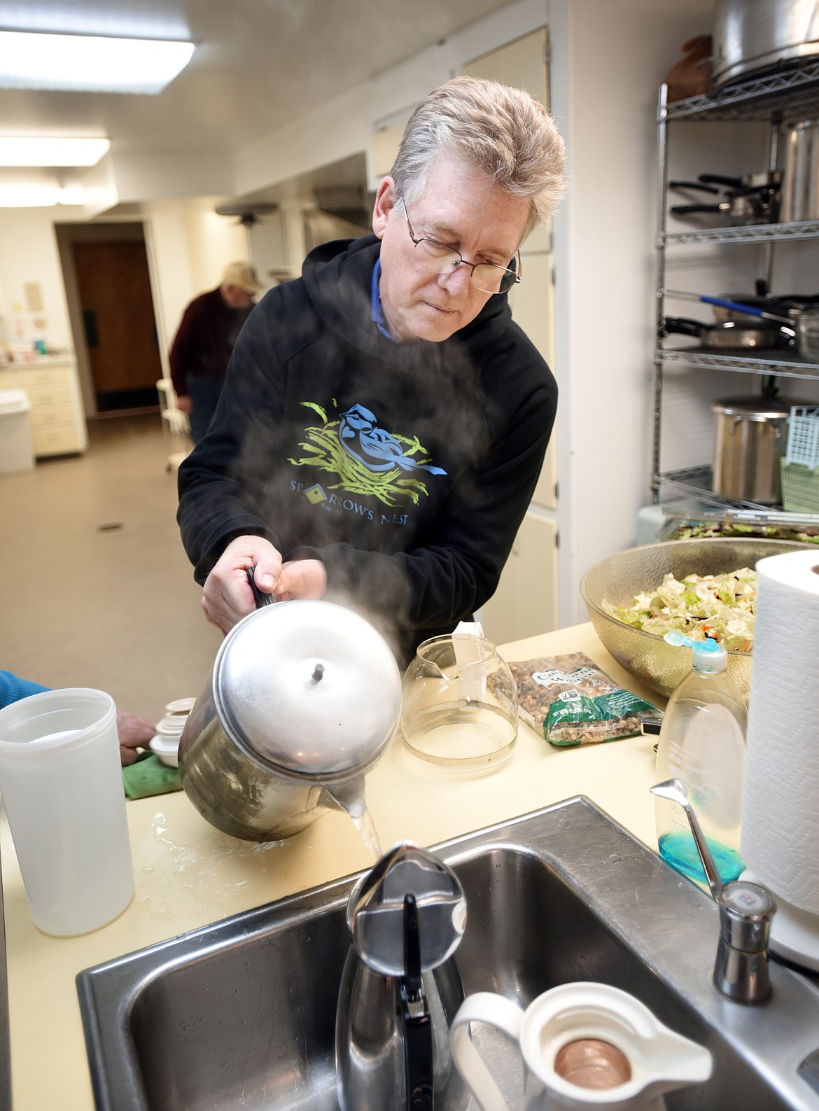 Bob Norwood, who volunteered with his wife Carol (not shown), adds hot water to various pots for coffee, tea and hot chocolate at Central Christian Church in Kalispell. Hot drinks are especially appreciated at this time of year, organizers said.
(Brenda Ahearn/Daily Inter Lake)