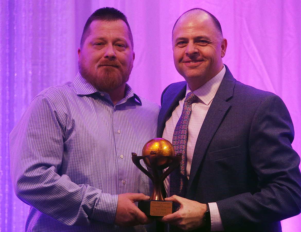 Mark Woodworth presents SC Frazer, left, with the Volunteer of the Year Award during the Post Falls Chamber of Commerce's Community Recognition Gala at Red Lion Templin's Hotel on Thursday night. Frazer, an Army veteran who served in Iraq and Afghanistan is a chamber of commerce board member, founding member of the Combat Veteran Riders, president of the Washington Fallen Heroes Project and board member of Time of Remembrance. (LOREN BENOIT/Press)