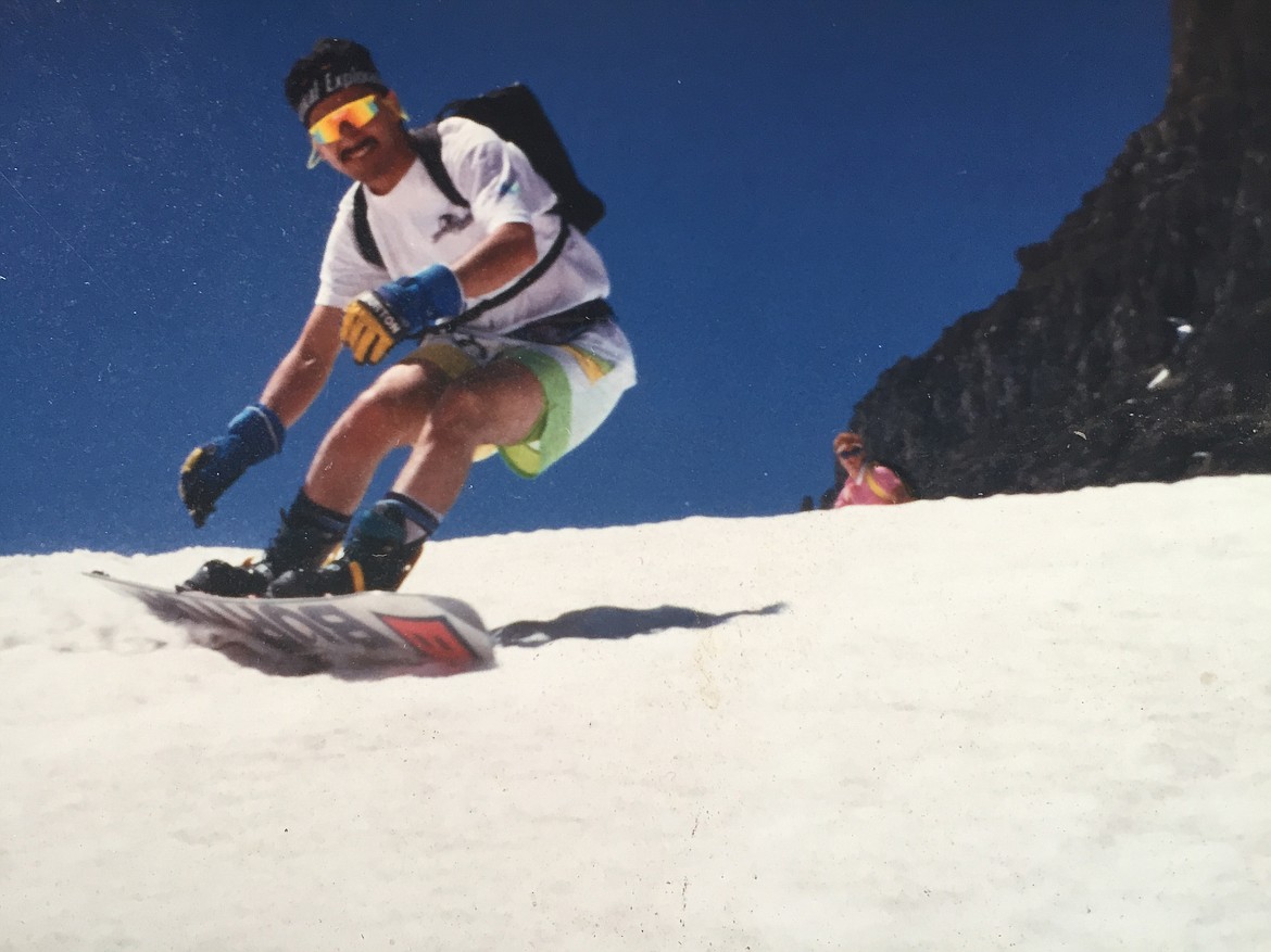 John McGinnis snowboards at Logan Pass in Glacier National Park in the early 1990s. Tim Mason in the background. (Casey Caldbeck photo)
