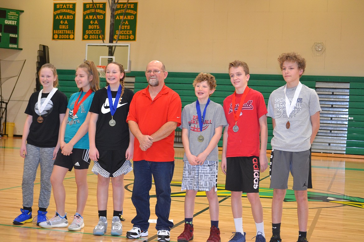 Courtesy photo
Pictured are the Coeur d&#146;Alene Elks Hoop Shoot 12-13 year-old winners &#151; from left, third place Marissa Needs, Bailey Nipp-Berger in second and first-place finisher Kamryn Pickford, Hoop Shoot Director Rick Alexander, boys&#146; champion Stockton Montague, runner-up Isaac Ziegler, and Deacon Kiesbuy in third place.