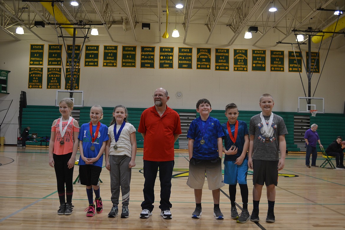 Courtesy photo
Pictured are the Coeur d&#146;Alene Elks Hoop Shoot 8-9 year old winners &#151; from left, third-place finisher Kailee Beck, runner-up Jaya Felix and champion Tori Ellwood, Hoop Shoot Director Rick Alexander, boys&#146; winner Tyler Zahcary, second place Gavin Tosi and Evan Robertson in third place.