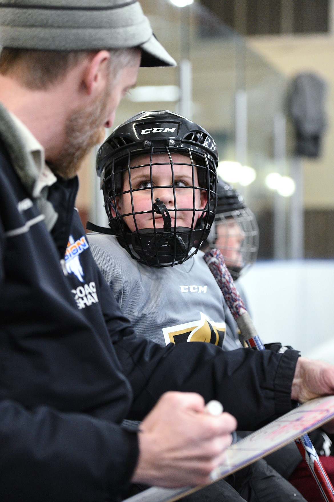 Coach Shawn Baker speaks to one of his players during a Yeti League game.