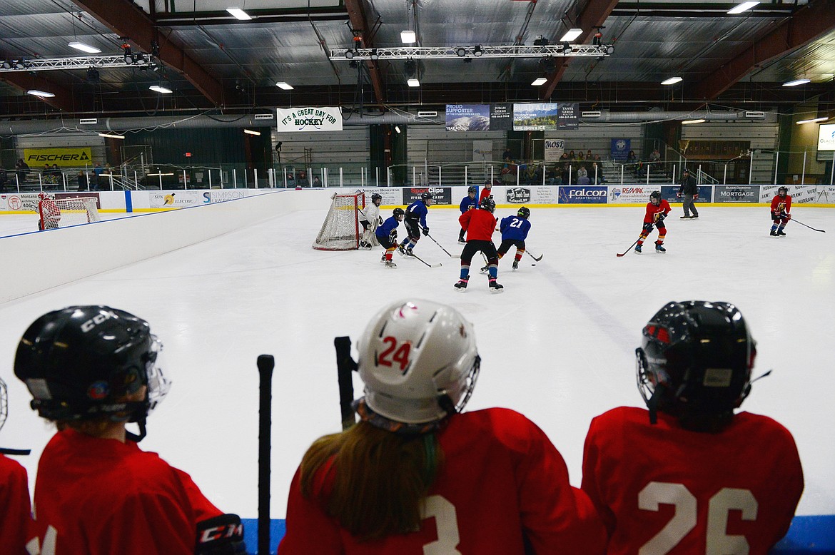 Players on the red team watch the action during a Yeti League game.