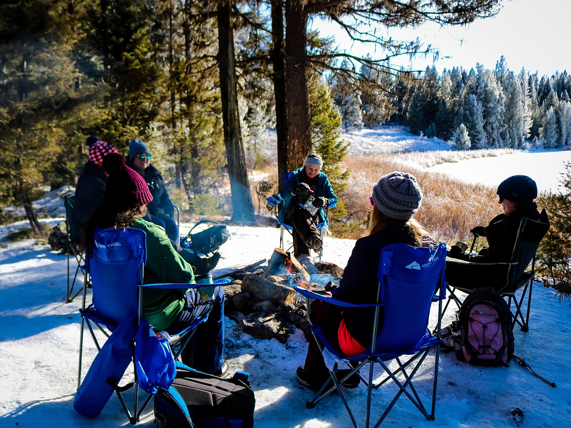 Women gather around a campfire during a winter outing offered by Rocky Mountain Women Outdoors. (Photo provided by Rocky Mountain Women Outdoors)
