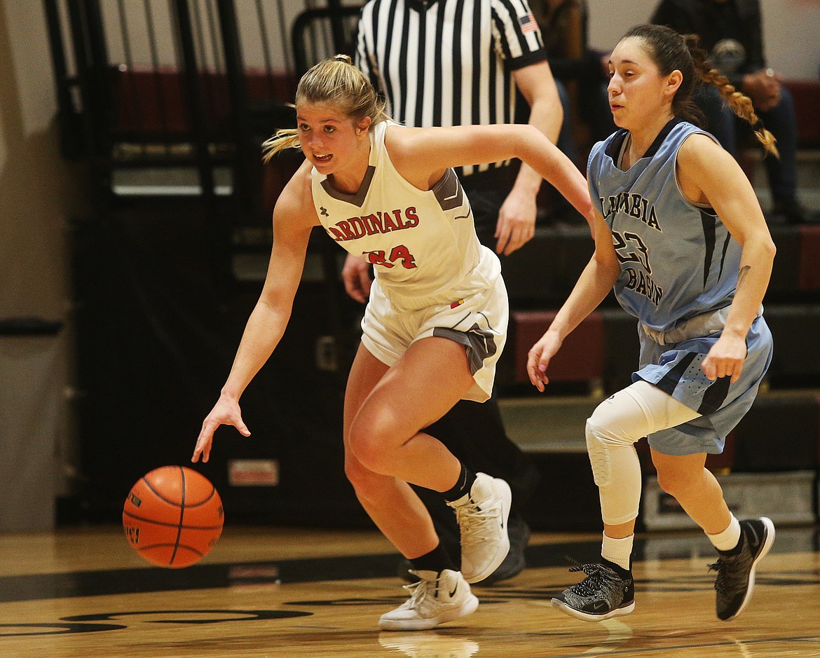 Photos: LOREN BENOIT/Press 
North Idaho College guard Alex Carlton dribbles the ball down the court while defended by Alexis Castro of Columbia Basin College in the second half of Monday&#146;s game at NIC.