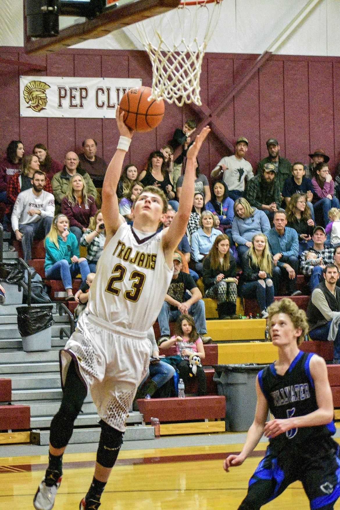 Troy senior Hunter Leighty follows up a steal by putting the Trojans up 23-2 over Stillwater against Stillwater Saturday. (Ben Kibbey/The Western News)