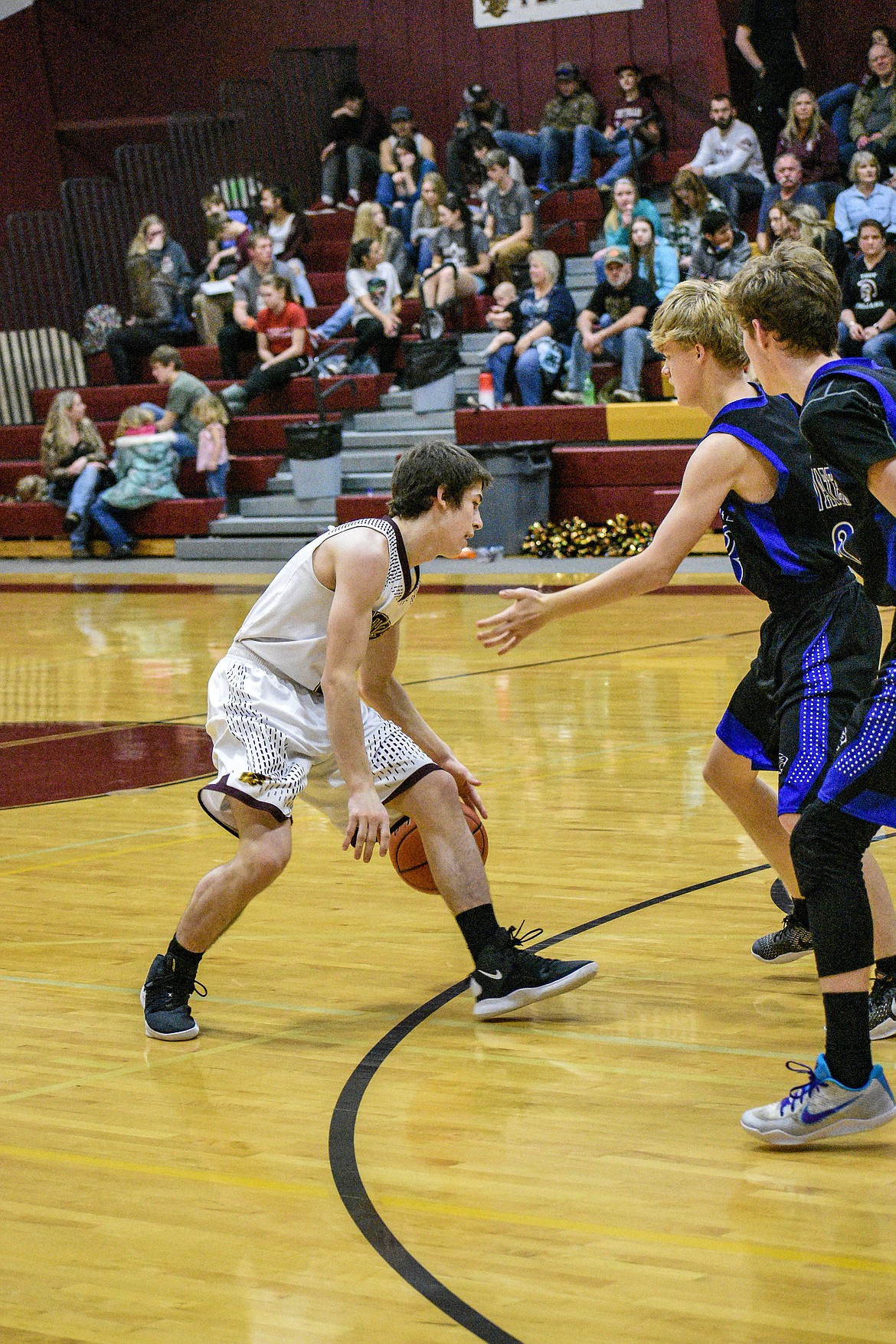 Troy senior Trevor Hoagland dribbles around the Stillwater defense during the third quarter Saturday. (Ben Kibbey/The Western News)