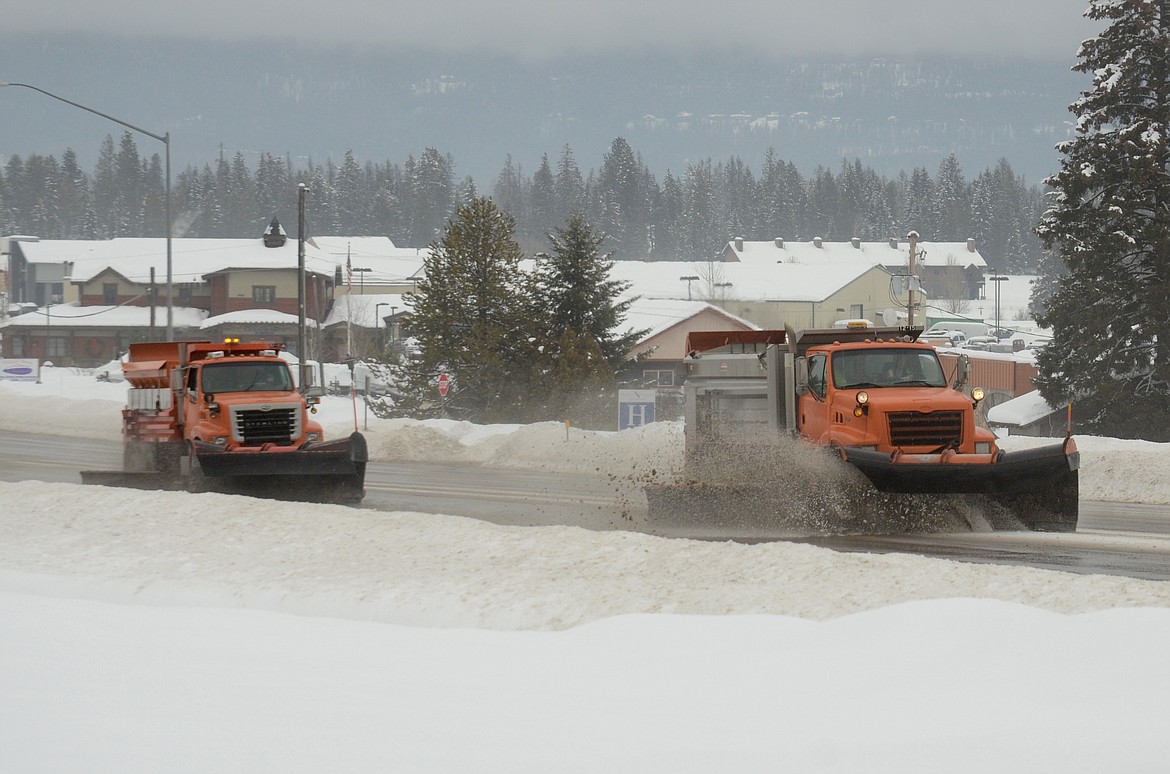 Plows move through Whitefish along U.S. 93 South in this file photo.