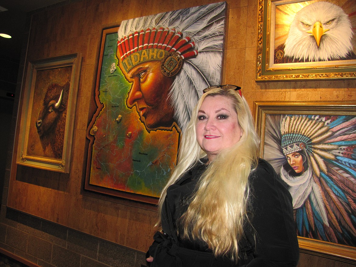 Contemporary artist Helga Tacke poses next to acrylic paintings she has on display through January at the Coeur d&#146;Alene Public Library. (KEITH ERICKSON/Coeur Voice)