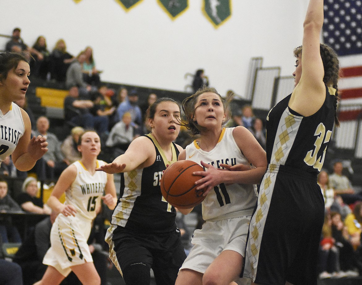 Claire Carloss fights through the lane during Saturday's battle with Stevensville. (Daniel McKay/Whitefish Pilot)