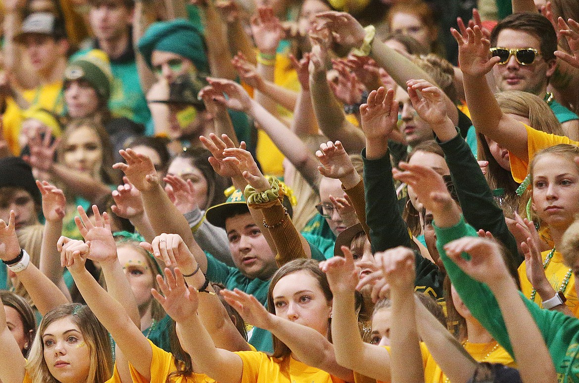 The Lakeland High student section raises its hands as a teammate shoots a free throw during Friday night&#146;s Battle for the Paddle.