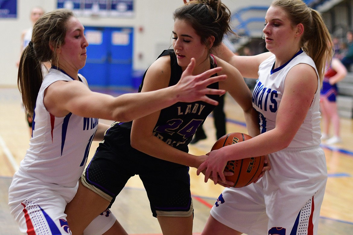 Josie Windauer, left, and Savvy Ellis play smothering defense against Polson's Misty Tenas Tuesday. (Jeremy Weber photo)