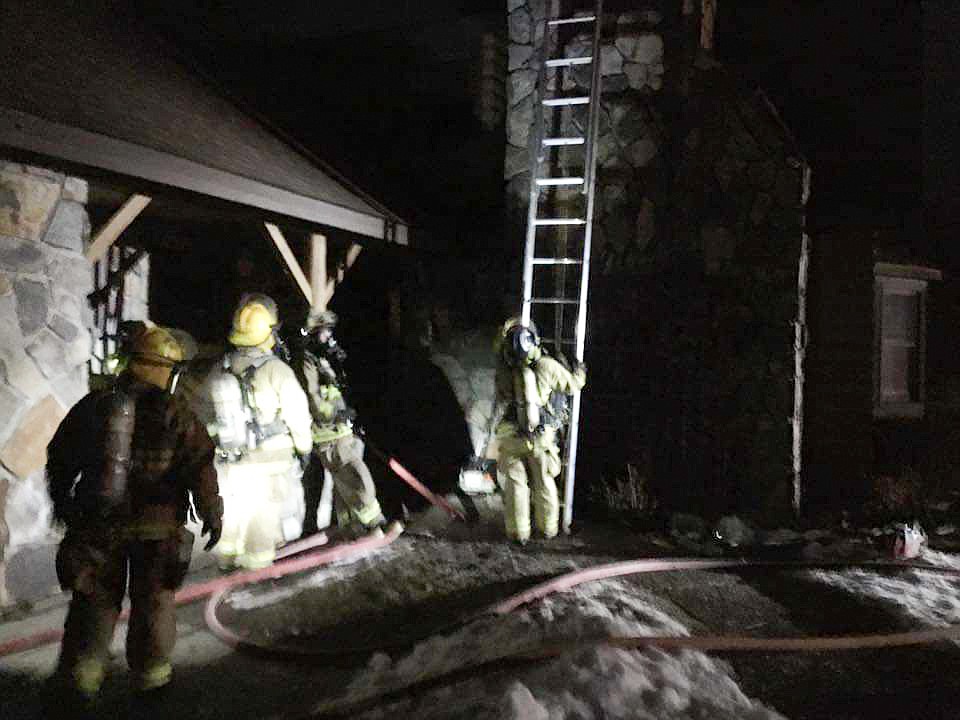 North Bench Fire personnel, with mutual aid from South Boundary Fire, work to put out a structure fire on Oxford Loop on Sunday night.