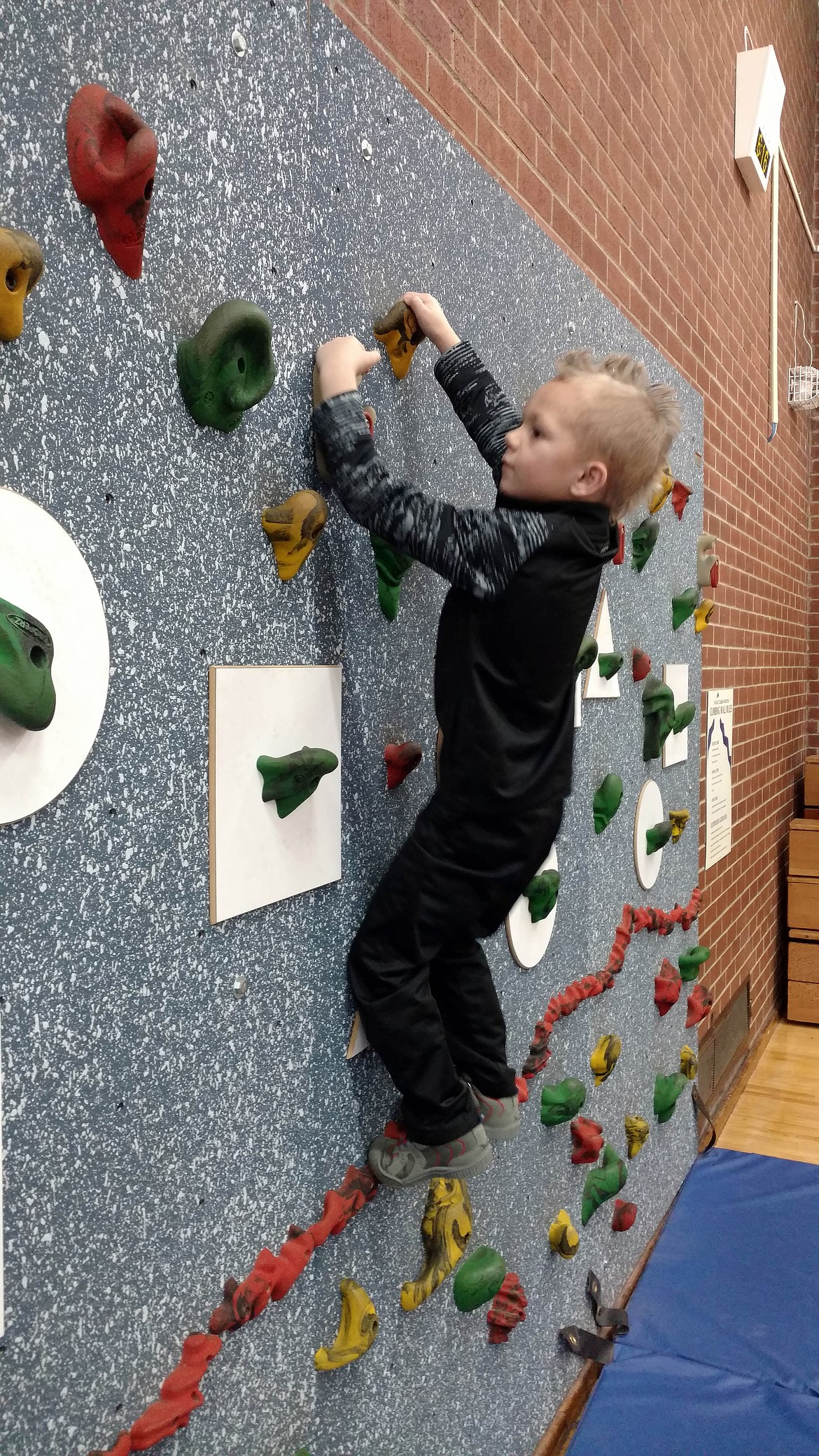 A little fella shows off his climbing chops on Pinehurst Elementary School&#146;s rock wall in the gymnasium.