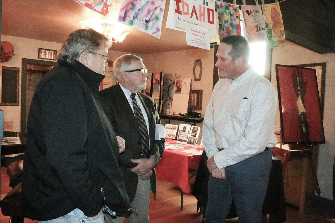 Photo by MANDI BATEMAN
Boundary County Human Rights Task Force Chairman Craig Kelson, from left, and speaker Robert Singletary talk with Bonners Ferry Mayor David Sims.