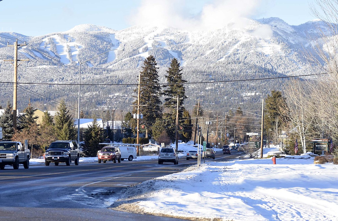 Cars drive along U.S. Highway 93. (Heidi Desch/Whitefish Pilot)