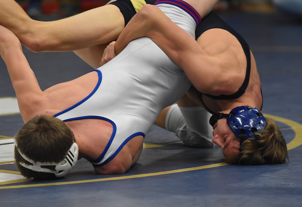 THOMPSON FALLS/NOXON grappler Roman Sparks (dark singlet), at 120 pounds, engaged Walker Murphy of Mission/Charlo in one of the most exciting of the championship matches at the Ted Kato Invitational on Saturday. Sparks scored on a takedown with 30 second left to win the class title. (Joe Sova/Clark Fork Valley Press)