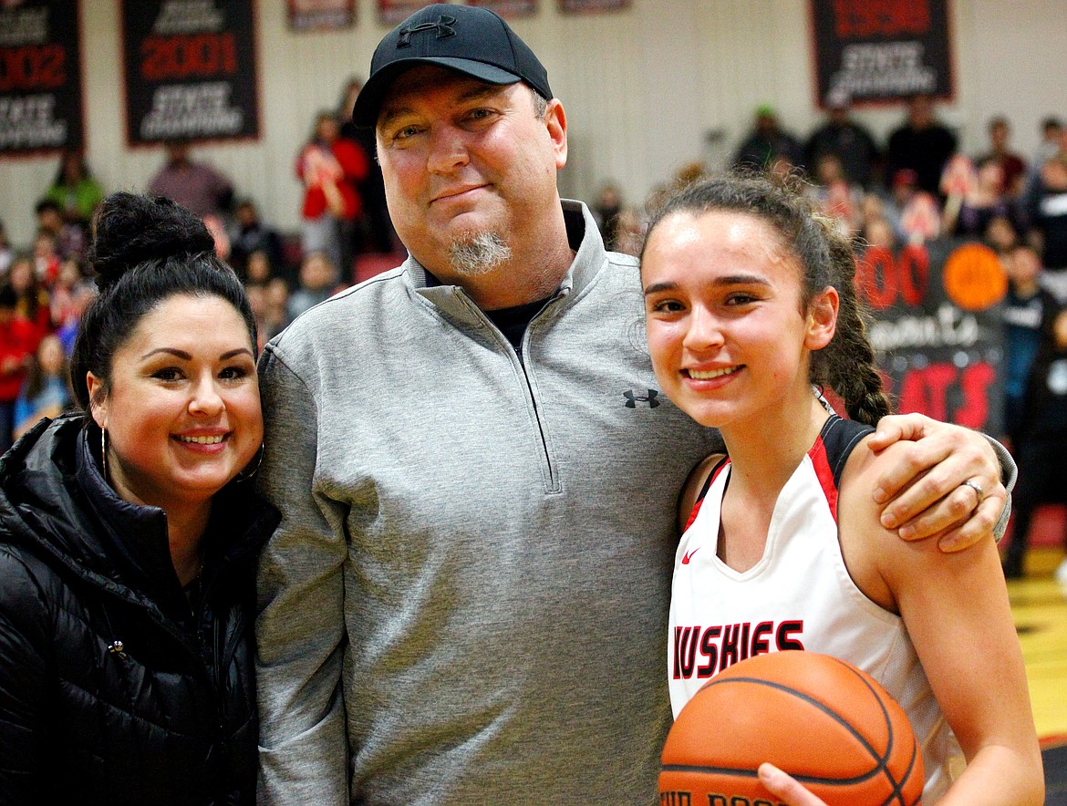 Rodney Harwood/Sun TribuneMatt and Elda Hampoton joined their daughter Macy on the floor for a brief ceremony celebrating her surpassing the 1,000-point milestone.