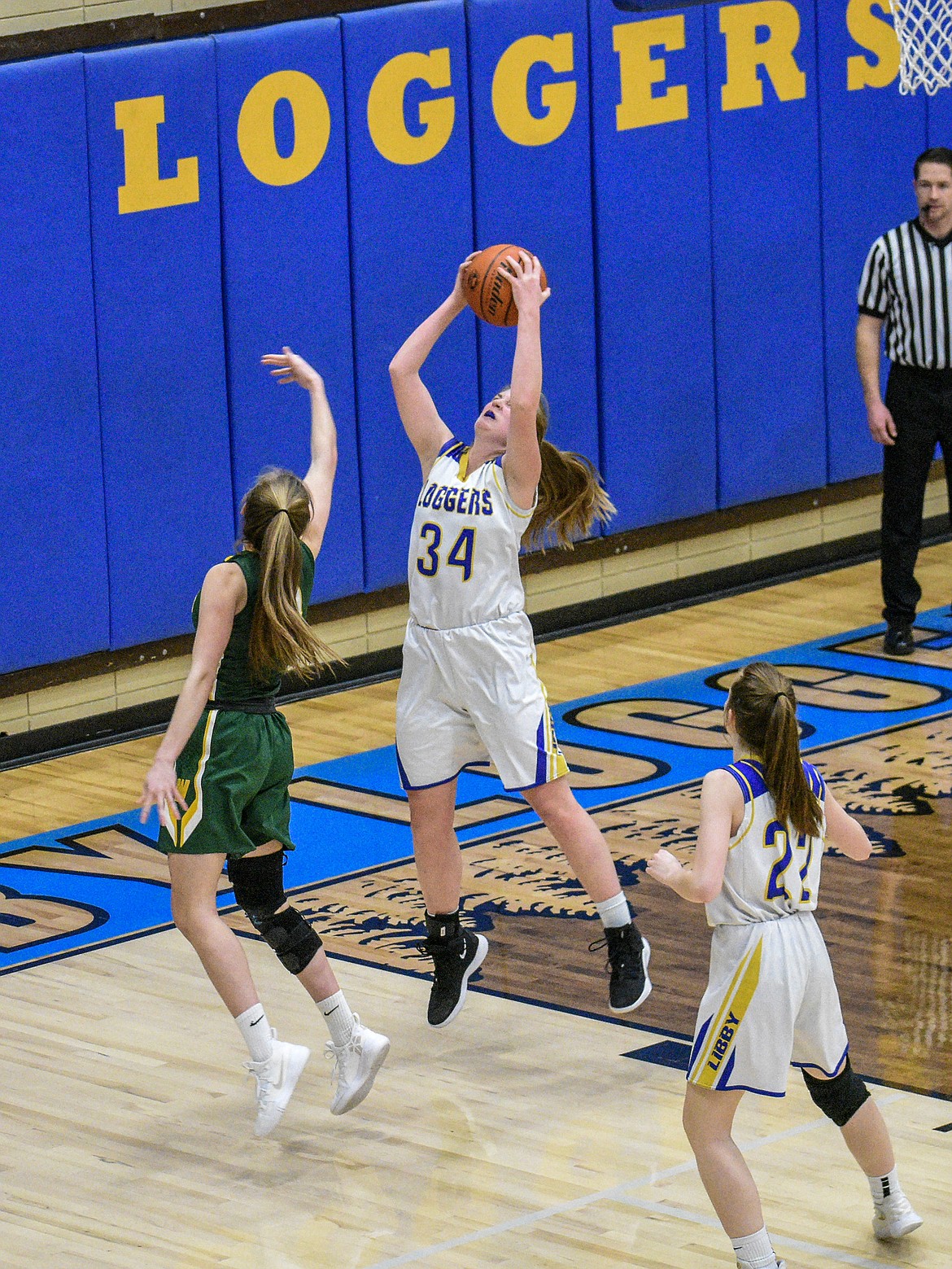 Libby junior McKenzie Proffitt gets a steal off a pass to Whitefish senior Kit Anderson late in the first quarter Saturday. (Ben Kibbey/The Western News)