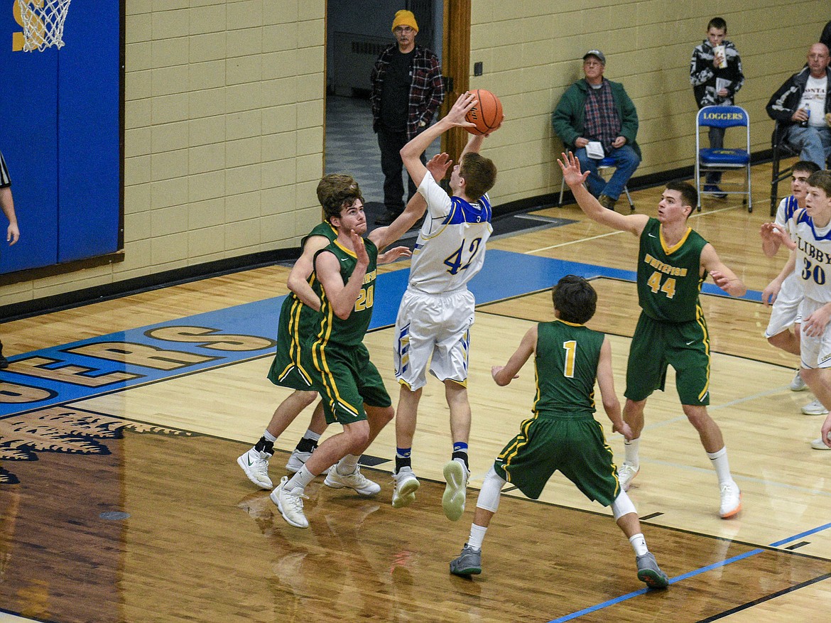 Libby junior Keith Johnson scores from inside the paint late in the third quarter, cutting the Whitefish lead down to 31-29 Saturday. (Ben Kibbey/The Western News)