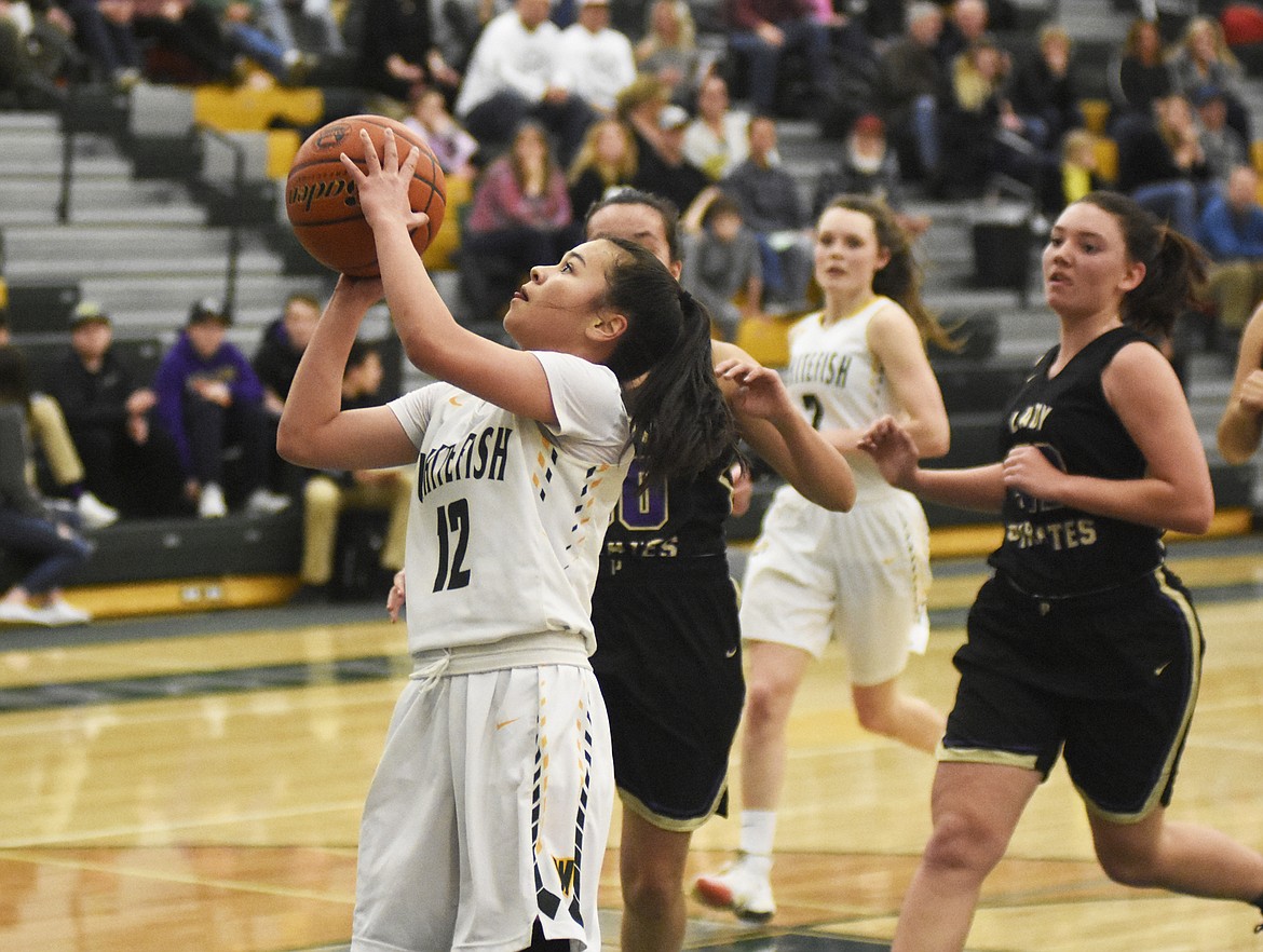 Jasmine Matern shoots from the post during Friday's win over Polson. (Daniel McKay/Whitefish Pilot)