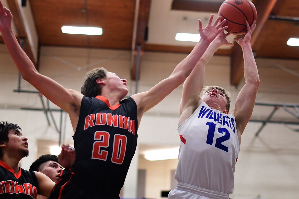 Drew Morgan battles Ronan&#146;s Zarec Couture for a rebound in the first quarter Tuesday. (Jeremy Weber photo)