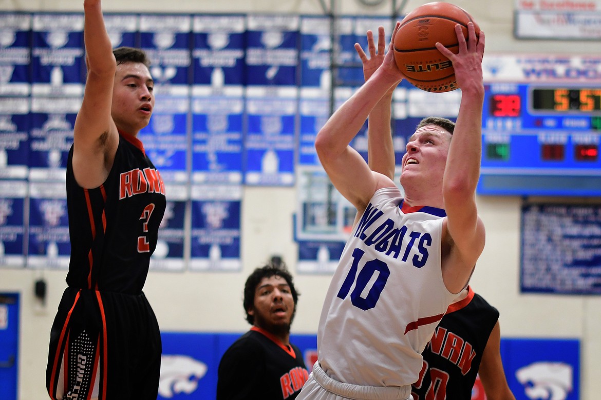 Dillon Wanner takes the ball inside against Ronan&#146;s Randy Finley in the fourth quarter Tuesday. (Jeremy Weber photo)