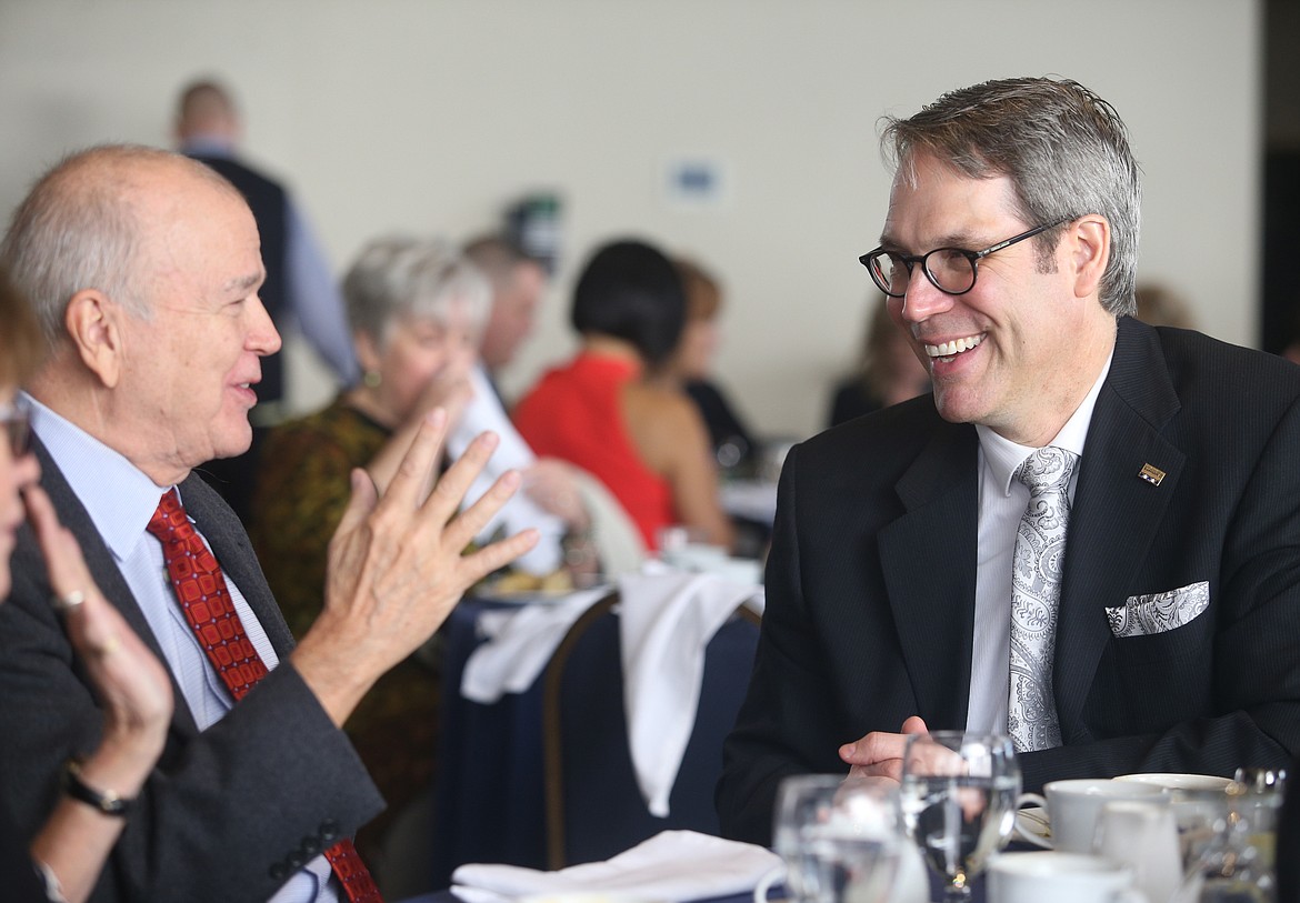 Coldwell Banker General Manager Rob Brickett, right, shares a laugh with former Coldwell Banker CEO Jim Gillespie during Scheidmiller Realty&#146;s annual awards banquet at the Hagadone Event Center on Wednesday. (LOREN BENOIT/Press)