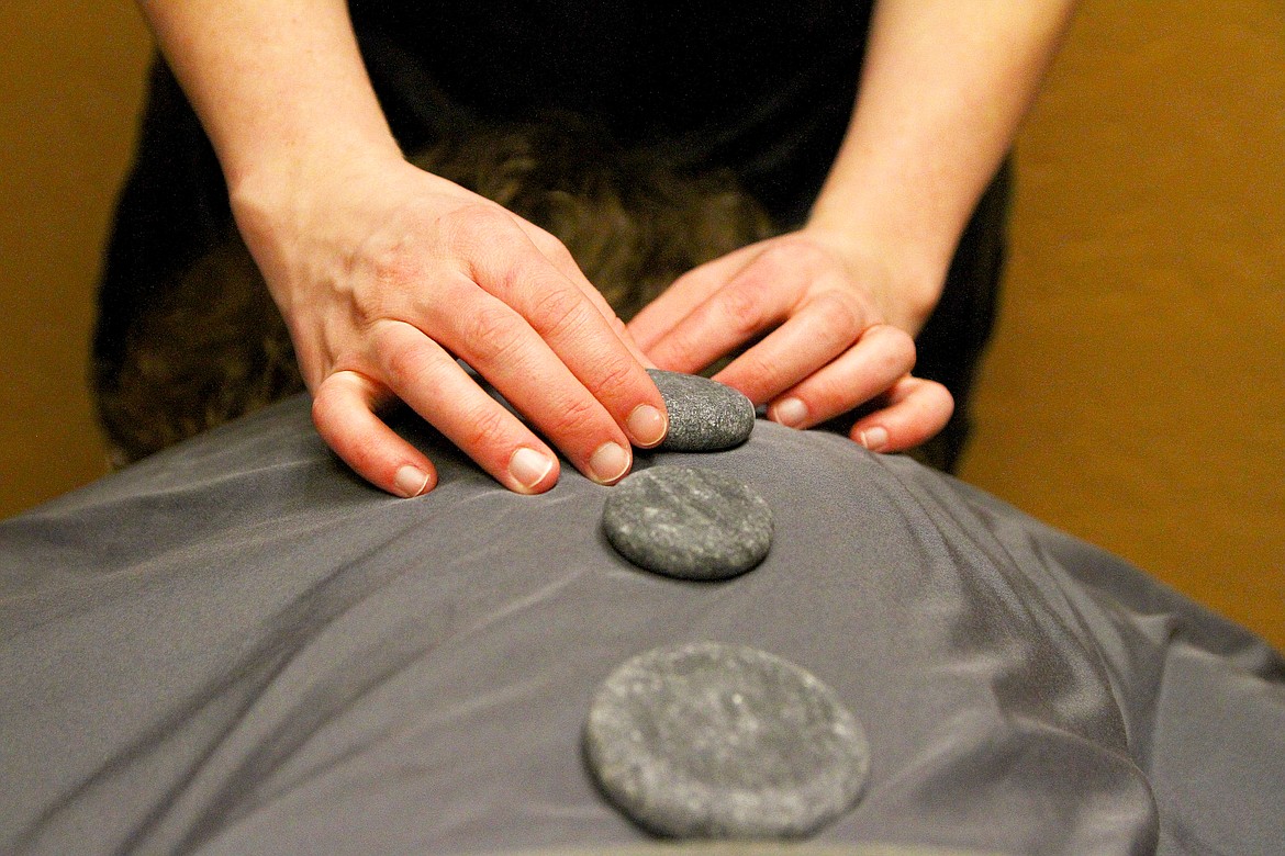 Gillis uses hot rocks are used to further relax damaged muscles and soft tissue.