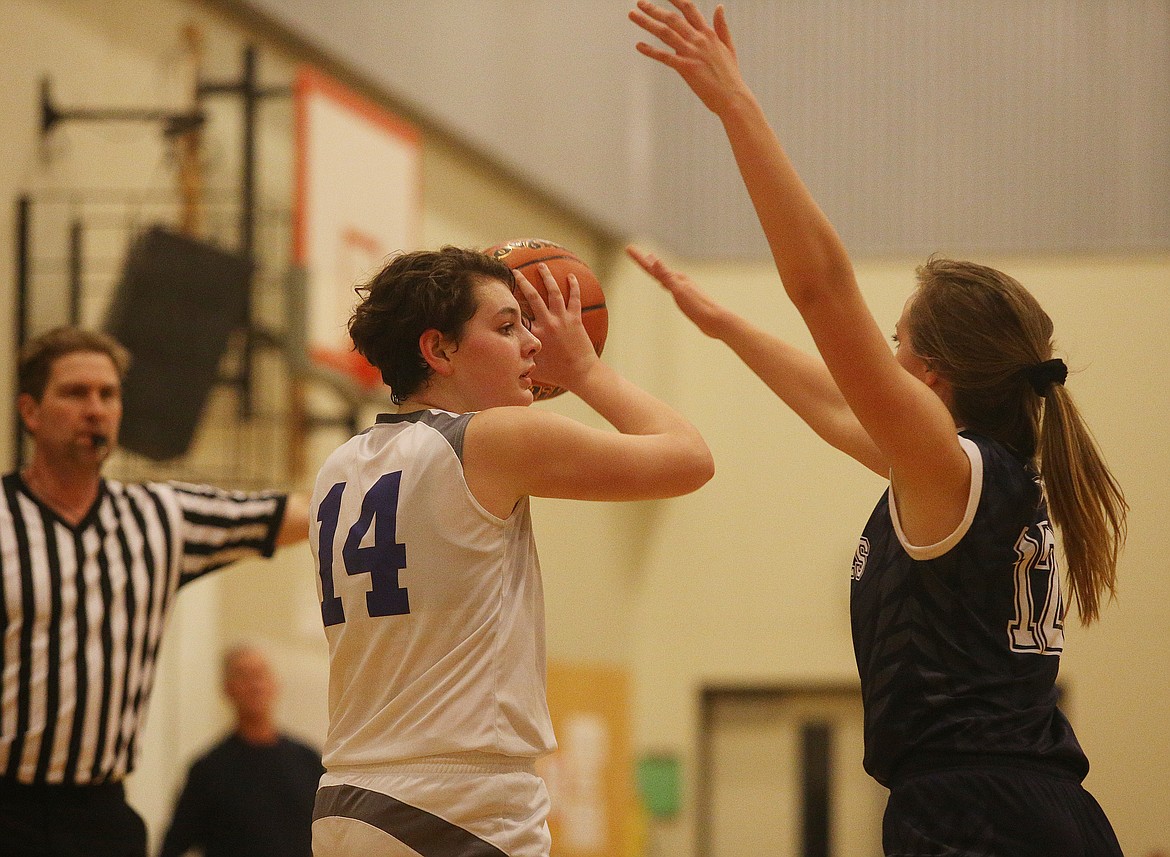North Idaho Christian&#146;s Rylee Overturf, left, looks to pass the ball to a teammate while defended by Annie Goetze of Pullman Christian School during Tuesday night&#146;s game at Holy Family Catholic School. (LOREN BENOIT/Press)