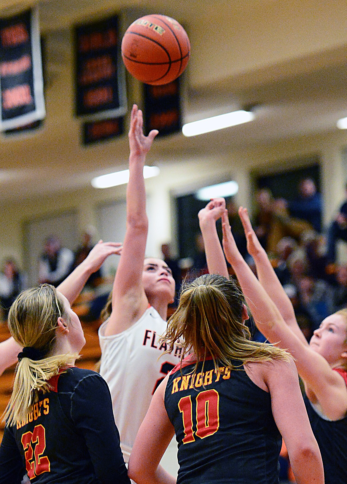 Flathead&#146;s Emily Lembke (2) releases a shot in the paint guarded by a trio of Missoula Hellgate defenders at Flathead High School on Thursday. (Casey Kreider/Daily Inter Lake)